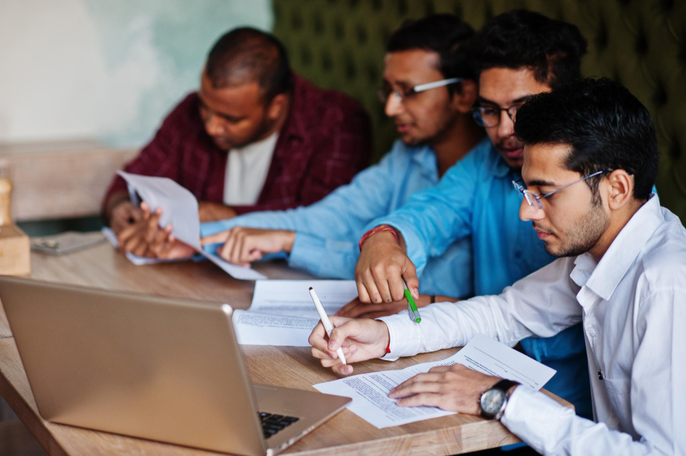 Team members reviewing documents together at a table